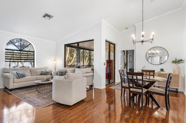 dining area with dark wood-type flooring, an inviting chandelier, and a healthy amount of sunlight