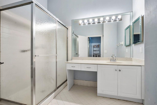 bathroom featuring vanity, tile patterned floors, and walk in shower