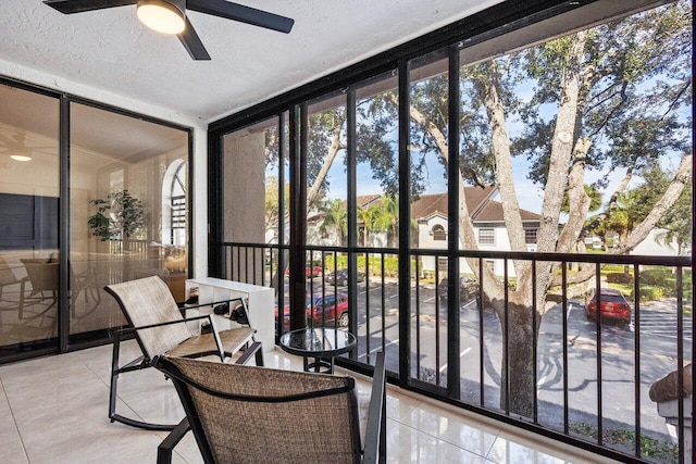 sunroom / solarium featuring ceiling fan and plenty of natural light