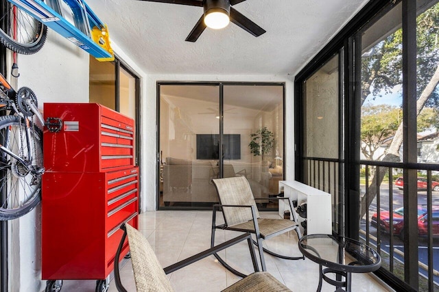 sunroom featuring ceiling fan