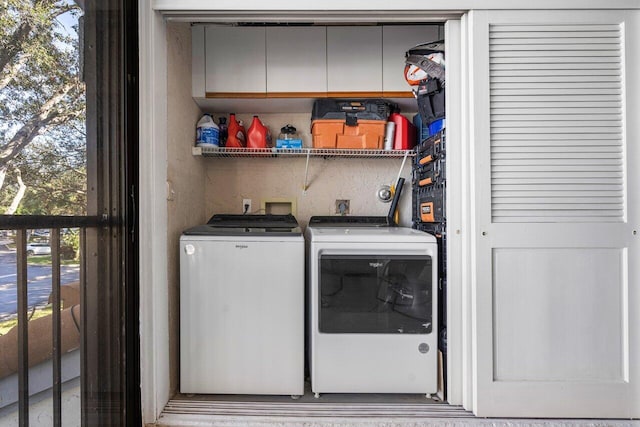 clothes washing area with washing machine and clothes dryer