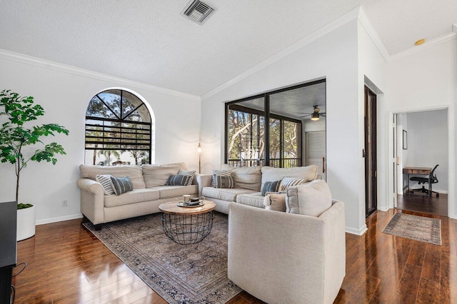 living room featuring ceiling fan, a healthy amount of sunlight, and a textured ceiling