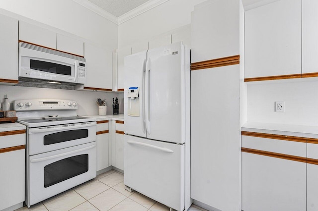 kitchen with white appliances, light tile patterned floors, a textured ceiling, ornamental molding, and white cabinetry