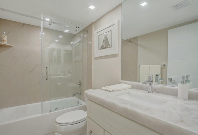 full bathroom with vanity, toilet, and enclosed tub / shower combo