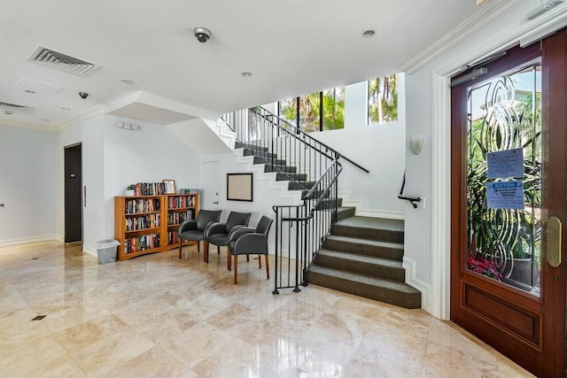 foyer featuring crown molding