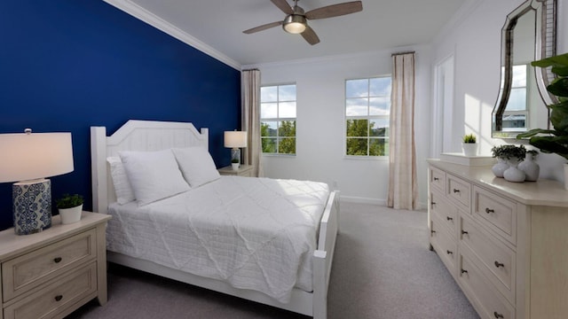 carpeted bedroom featuring ceiling fan and crown molding