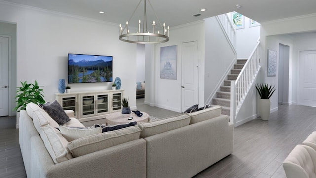 living room featuring hardwood / wood-style floors, an inviting chandelier, and ornamental molding