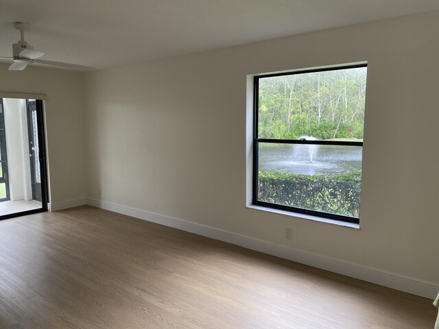 sitting room featuring wood finished floors, baseboards, and ceiling fan