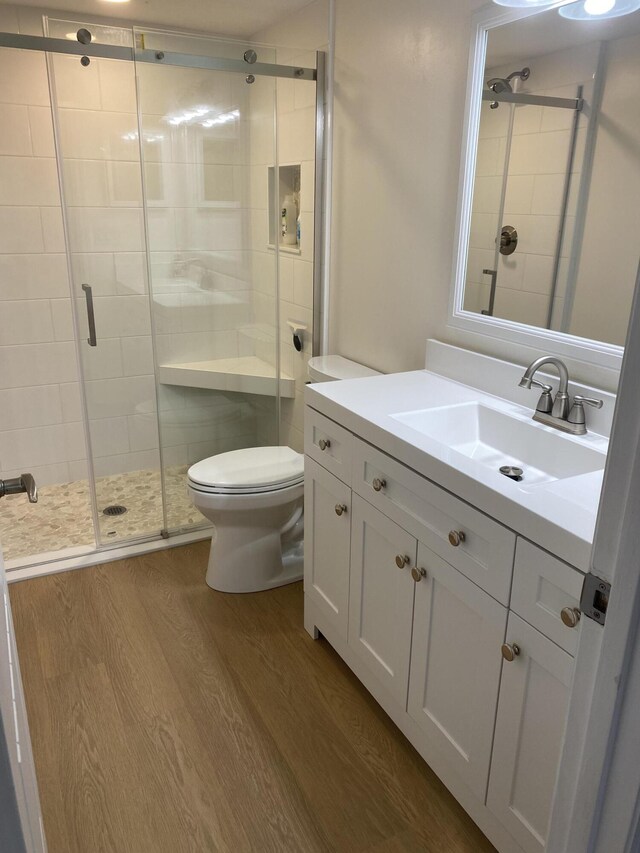 unfurnished bedroom featuring wood finished floors, a closet, and baseboards