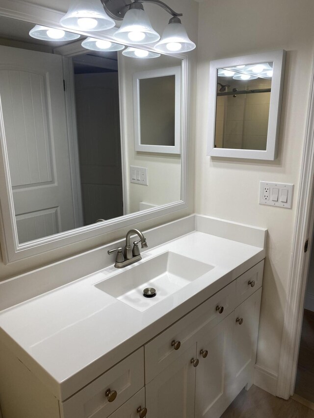 empty room featuring baseboards, wood finished floors, and a ceiling fan