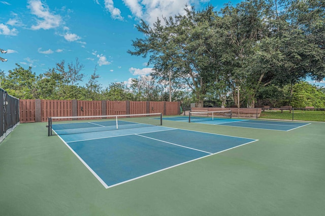 view of tennis court featuring fence