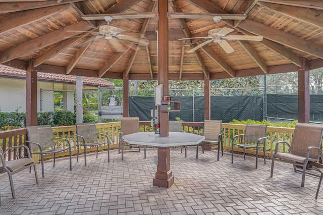 view of patio with a gazebo, ceiling fan, and fence