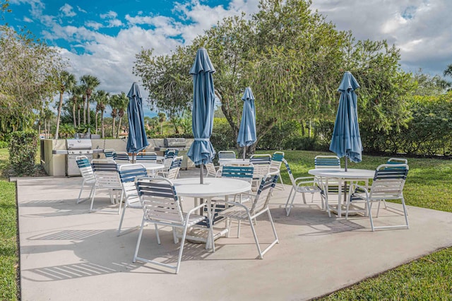 view of patio / terrace featuring outdoor dining area and a grill