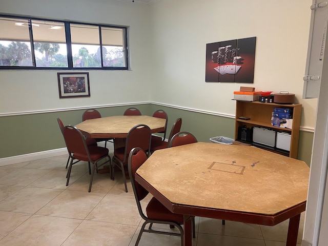 dining area with light tile patterned flooring and baseboards