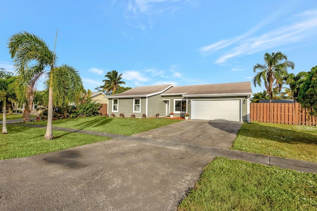 single story home with a front yard and a garage