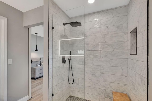 bathroom with hardwood / wood-style flooring and a shower with door