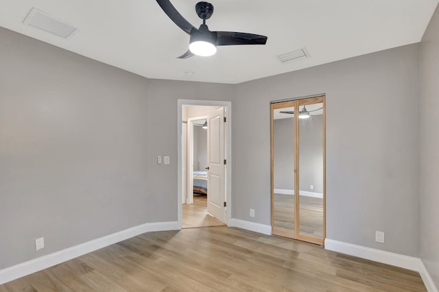 unfurnished bedroom featuring a closet, ceiling fan, and light hardwood / wood-style floors