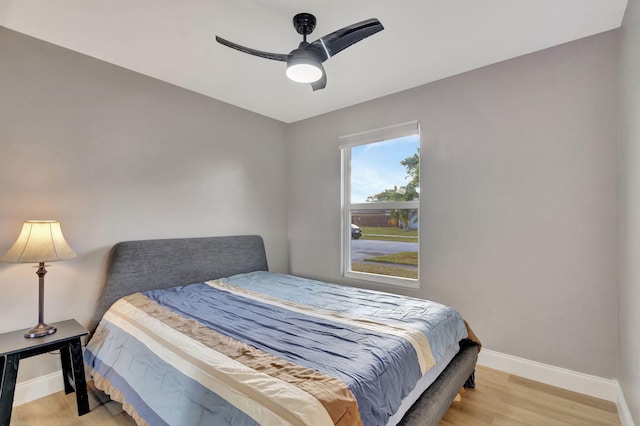 bedroom with ceiling fan and light hardwood / wood-style floors