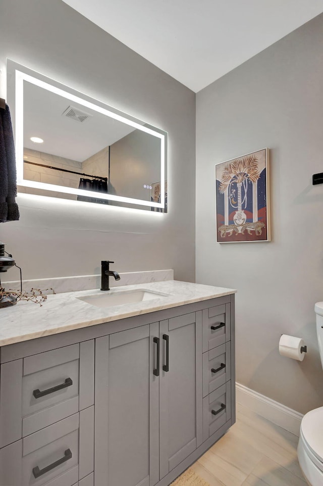 bathroom featuring vanity and toilet