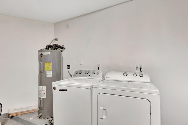 clothes washing area with electric water heater and washer and clothes dryer