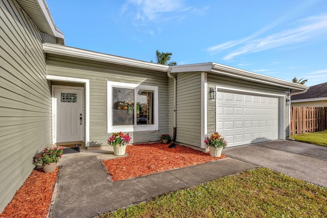 doorway to property with a garage