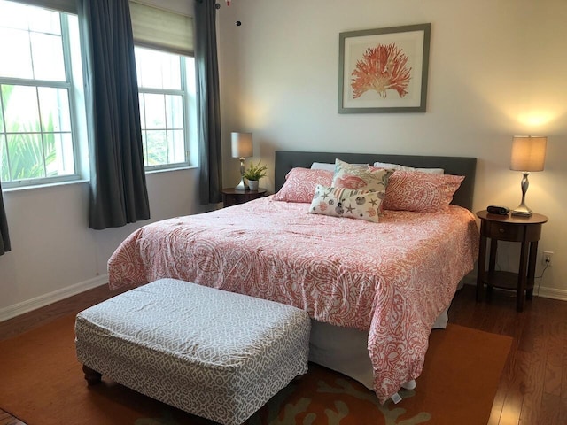 bedroom with dark wood-type flooring