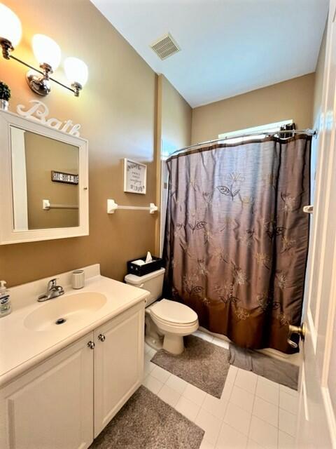 bathroom with tile patterned floors, vanity, and toilet