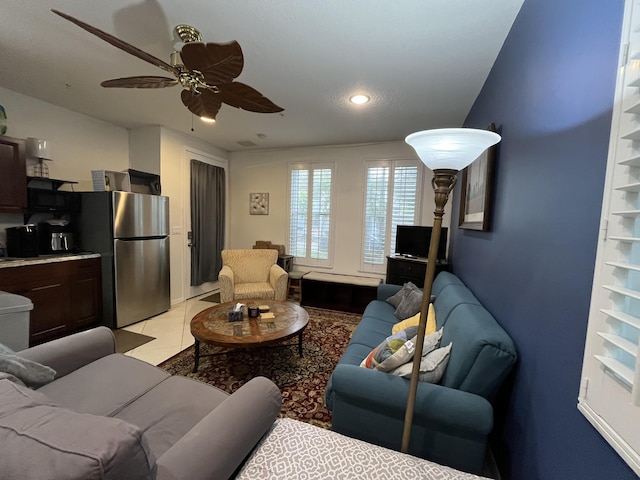 living room featuring light tile patterned floors and ceiling fan