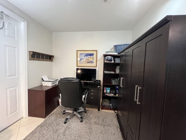 home office with light tile patterned floors and a textured ceiling