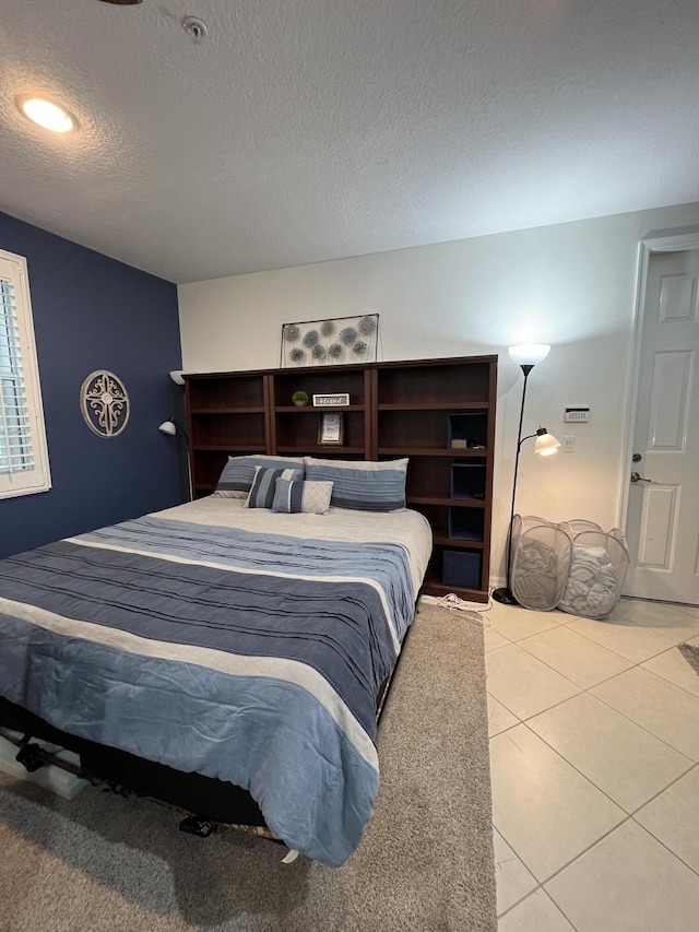 tiled bedroom with a textured ceiling