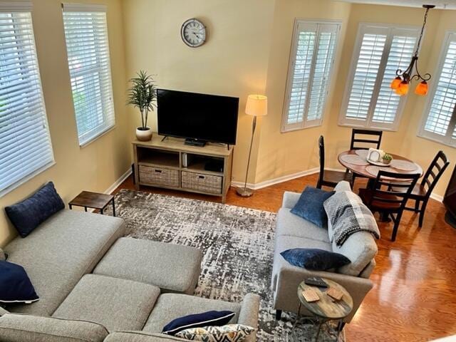 living room featuring a chandelier and wood-type flooring