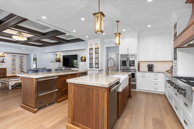 kitchen with pendant lighting, white cabinetry, and a large island