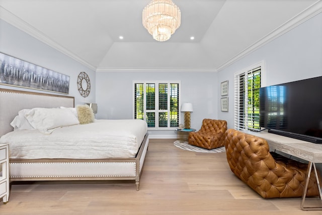 bedroom featuring multiple windows, a tray ceiling, a notable chandelier, and vaulted ceiling