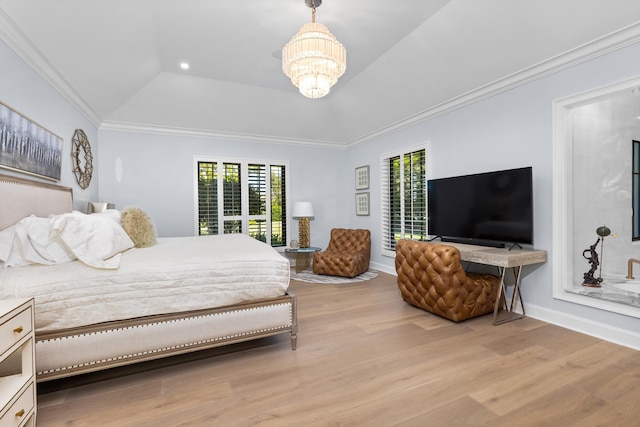 bedroom with multiple windows, light wood-type flooring, a notable chandelier, and a raised ceiling