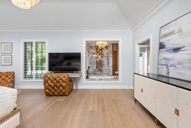 living room featuring an inviting chandelier, light wood-type flooring, vaulted ceiling, and ornamental molding