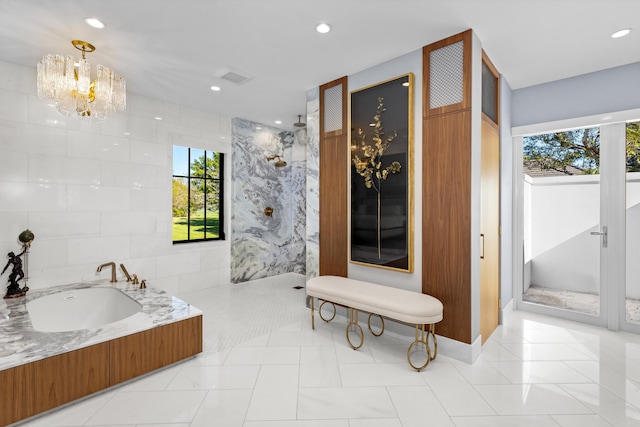 bathroom featuring a healthy amount of sunlight, tile walls, and tile patterned flooring