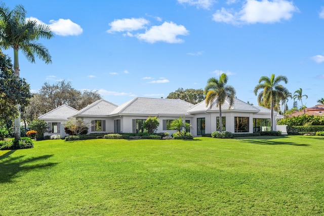 ranch-style home with a front lawn