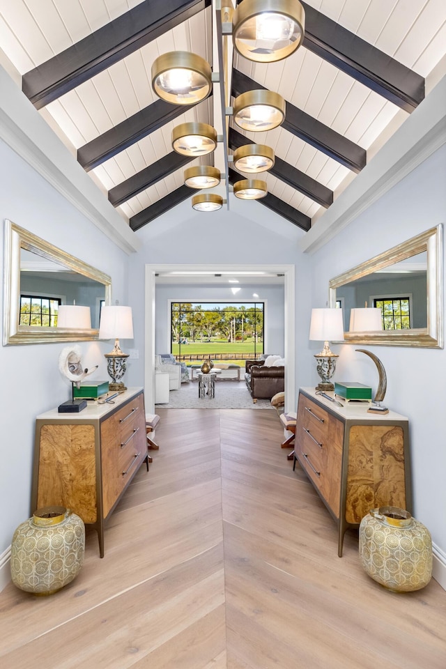 hallway with light hardwood / wood-style flooring and lofted ceiling with beams