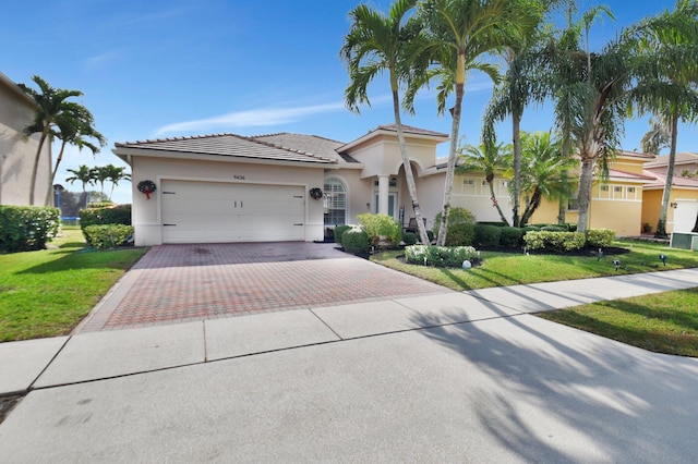 view of front of property with a garage and a front lawn