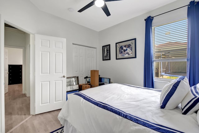 bedroom featuring light wood-type flooring, a closet, and ceiling fan