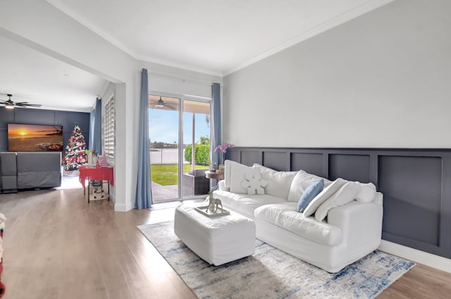 living room with light hardwood / wood-style floors and ornamental molding