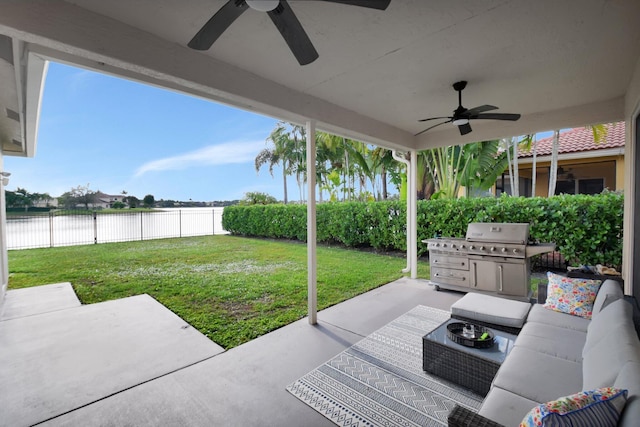 view of patio / terrace with an outdoor living space, a water view, ceiling fan, and a grill