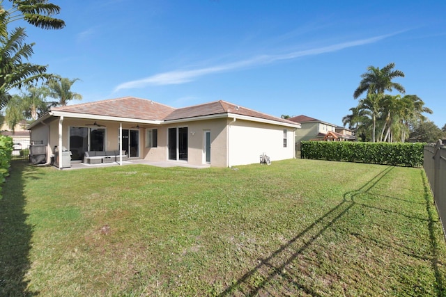 back of house featuring a lawn, a patio area, ceiling fan, and an outdoor hangout area