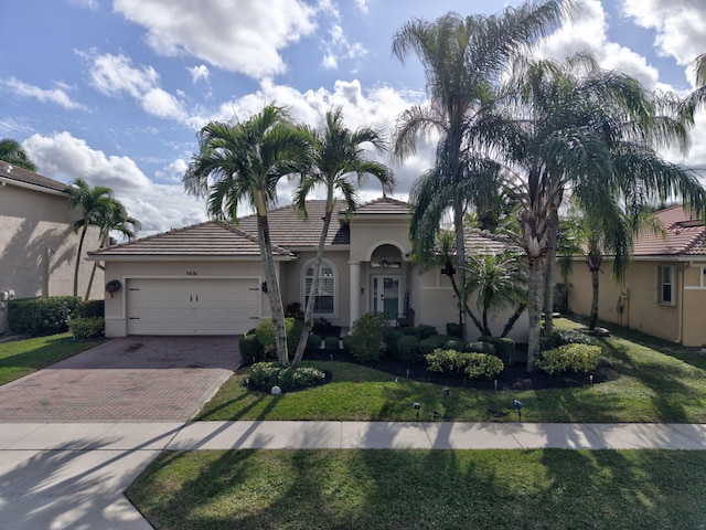 view of front of home featuring a garage and a front lawn