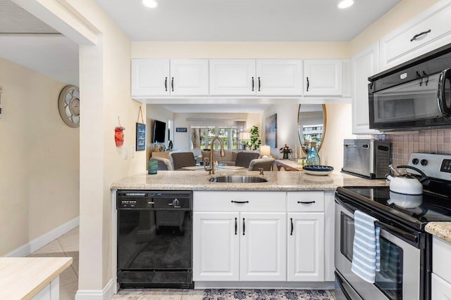 kitchen with light tile patterned floors, sink, white cabinetry, and black appliances