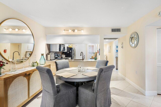 dining space featuring light tile patterned flooring