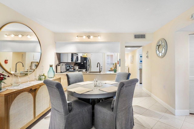 tiled dining space featuring sink