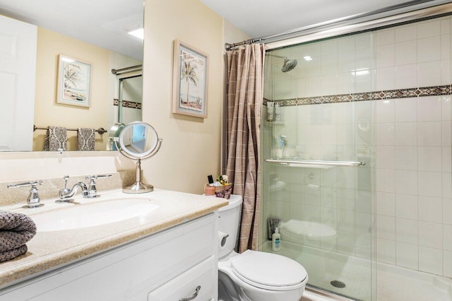 bathroom featuring vanity, curtained shower, and toilet