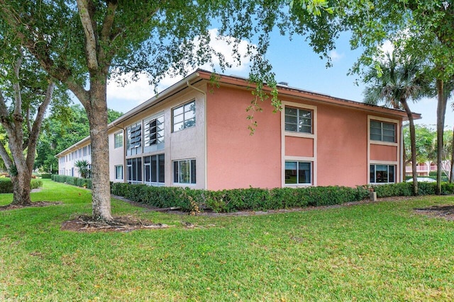 view of property exterior featuring a lawn