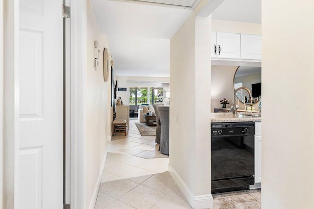 hall with light tile patterned floors and sink